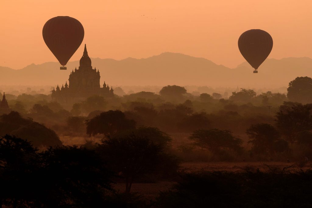 Sunrise in Bagan, Myanmar. Hot air balloons over pagodas