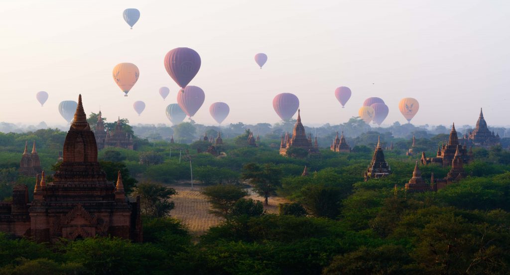 Sunrise in Bagan, Myanmar. Hot air balloons over pagodas