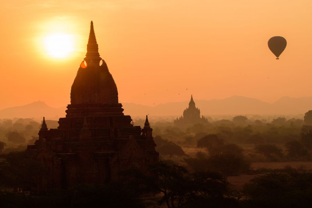 Sunrise in Bagan, Myanmar. Hot air balloon and pagodas