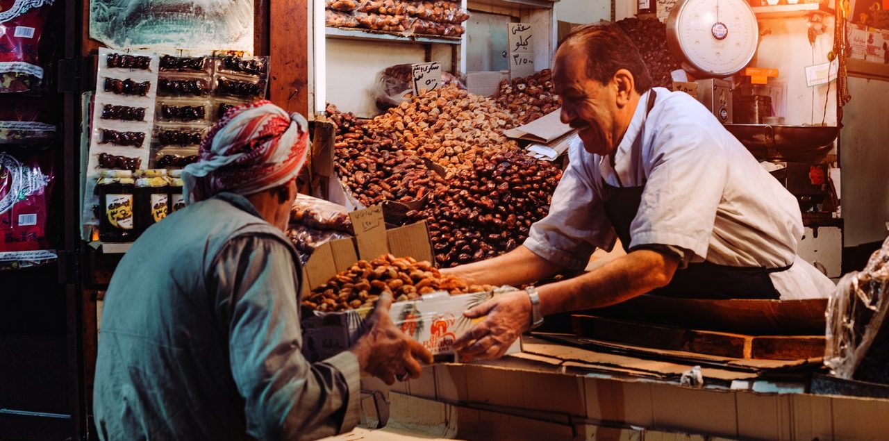 bartering, 2 men selling in a market