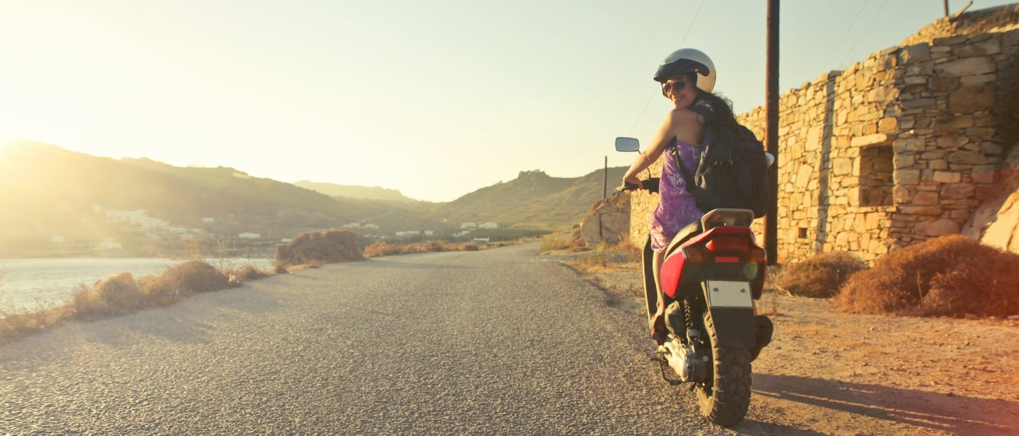 riding a moped woman holiday sunny day