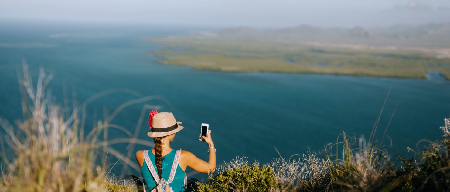 travel app woman holding her phone