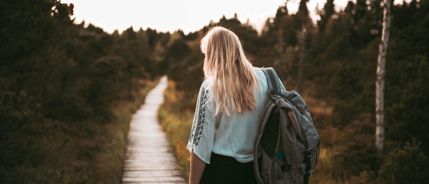 packing woman walking through footpath