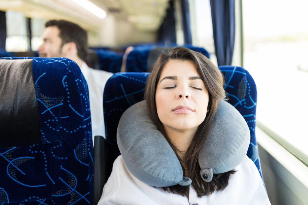 woman asleep using a travel pillow